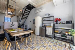 a kitchen with a dining table and a refrigerator at Birkirkara Typical 2BDR Townhouse in Birkirkara
