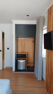 a kitchen with a stainless steel appliance in a room at Hotel Amadora Palace in Amadora