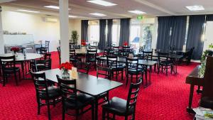 a dining room with tables and chairs and red carpet at Coonalpyn Hotel in Coonalpyn