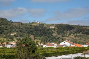 a town on top of a hill with houses at GuestReady - Santo Amaro apartment in Vila Franca do Campo