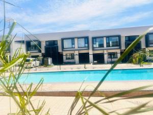 a swimming pool in front of a building at Platinum apartments in Gaborone