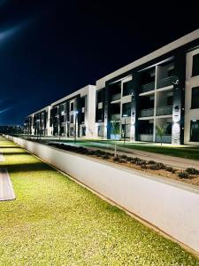 a large white building with a long row of windows at Platinum apartments in Gaborone
