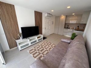 a living room with a couch and a flat screen tv at Vista Mar in Mogán