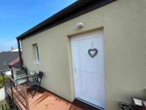 a white garage door with a heart on it at Aurum Vendégház in Esztergom +12 photos