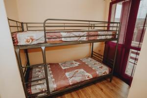 two bunk beds in a room with a window at къща за гости При Приятели in Nesebar +20 photos