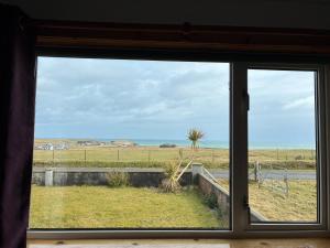 a window with a view of a field of grass at Buttof Lewis B&B in Lionel
