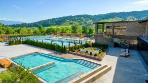 an outdoor swimming pool with a resort at Grand Hotel Therme in Banya