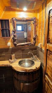 a bathroom with a sink in a barrel room at Vikendica Pustolov - Uvac, Zlatar in Nova Varoš