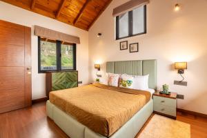 a bedroom with a bed and a window at Summerfield Manor 5 Bedroom Garden Estate in Bhīm Tāl