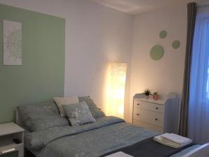 a small bedroom with a bed and a dresser at Hey! Central Apartment in Gheorgheni