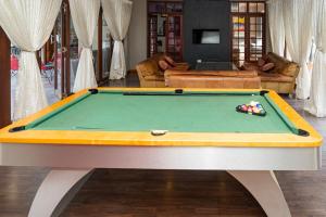 a billiard table in a living room with at Cu Guest House in Phalaborwa