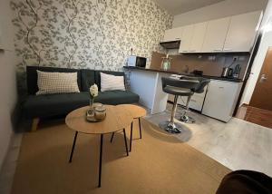 a living room with a couch and a table at Harmony Apartman in Dunajská Streda