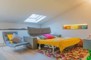 a room with a table and chairs and a skylight at Loft Della Baia a Due Passi dal Mare in Sestri Levante