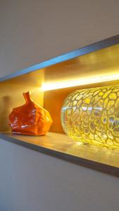 two glass vases are sitting on a shelf at Loft Della Baia a Due Passi dal Mare in Sestri Levante