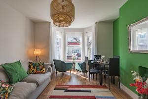 a living room with a couch and a table at Folkestone Apartments in Folkestone