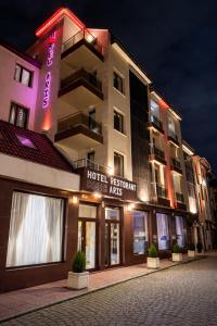 a hotel resort with a hotel sign on a building at Hotel Aris in Sofia