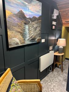 a waiting room with a painting on the wall at BELLFIELD HOUSE in Broadford