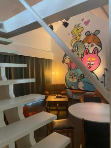 a room with a staircase with a mural on the wall at De Buitenmuur in Turnhout