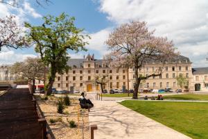 a large building with trees in front of it at Ibis Bourges Centre, Hôtel Restaurant in Bourges