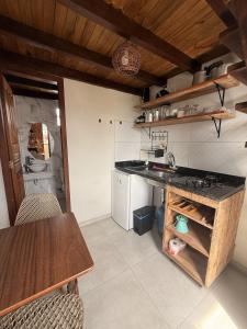 a kitchen with a counter and a table in it at Casaboa Apartamentos Passarela in Itacaré +30 photos