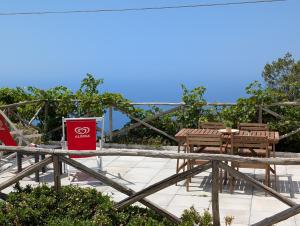 a patio with a table and chairs and a sign at Louis House ad Agerola per Amalfi Positano Pompei in Agerola