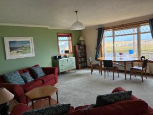 a living room with a couch and a table at Buttof Lewis B&B in Lionel