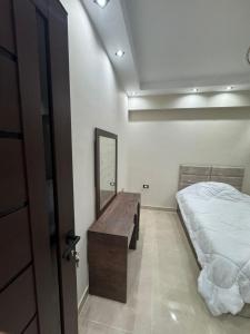 a bedroom with a bed and a mirror in it at Sharm Glow Villa in Sharm El Sheikh