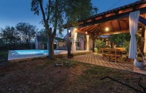 a house with a swimming pool and a wooden pergola at House Back to nature in Drniš