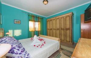 a bedroom with a bed with red flowers on it at House Back to nature in Drniš +23 photos