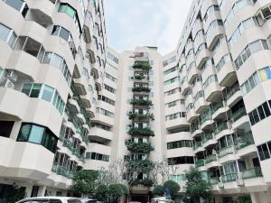 an apartment building with plants on the balconies at Sweet room in Nimnan in Chiang Mai