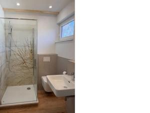 a bathroom with a sink and a shower at Ferienzimmer Präkel in Kloster
