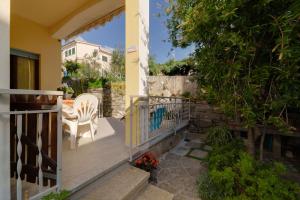 a balcony of a house with a table and a chair at Appartamento Pomonte la Posta - Goelba in Pomonte +18 photos