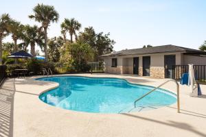 a swimming pool in a yard with a house at Home Inn & Suites in Orlando