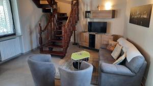 a living room with a couch and chairs and a tv at CORTE MORONA in Marmirolo