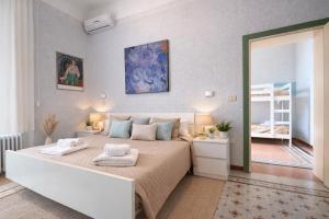a bedroom with a large bed with two towels on it at Hotel Villa Pina in Senigallia