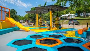 a playground with a slide and a play structure at Easyatent Mobile home Bijela Uvala in Poreč