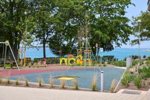 a park with a playground in the water at Easyatent Mobile home Bijela Uvala in Poreč +31 photos