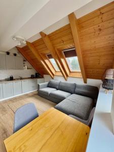 a living room with a couch and a table at Apartman Riviera 41 in Lipno nad Vltavou