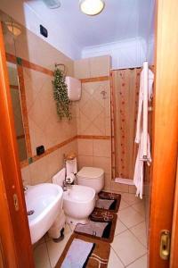 a bathroom with a toilet and a sink at Hotel Ginevra in Naples +88 photos