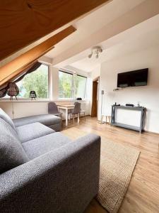a living room with a couch and a table at Apartman Riviera 41 in Lipno nad Vltavou
