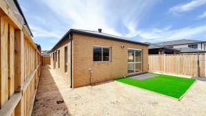 a brick house with a green lawn in the courtyard at Westbrook 3B3B Home by GoodLive in Truganina