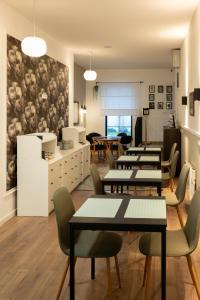 a group of tables and chairs in a room at MiniCity Inn in Belgrade