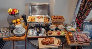 a table filled with lots of different types of food at Lord Byron Luxury Suites in Missolonghi