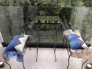two chairs and a table on a patio at Lord Byron Luxury Suites in Missolonghi