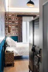 a bedroom with a bed in a room with a window at Lord Byron Luxury Suites in Missolonghi