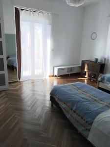 a bedroom with a bed and a large window at la casa di Shanti in Avigliana
