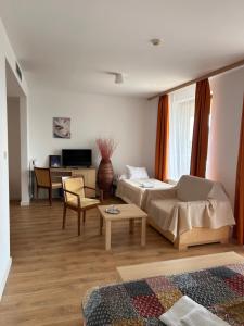 a living room with a bed and a table at Hotel Legend in Dunajská Streda +59 photos