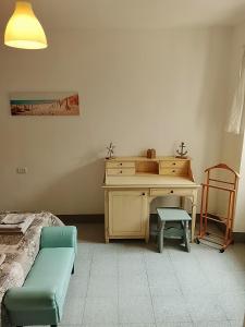 a bedroom with a desk and a chair and a couch at da Roy in Scansano +12 photos
