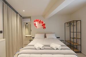 a bedroom with a large bed with white pillows at VF34 Patio House in Ermoupoli