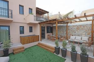 a patio of a home with a wooden pergola at VF34 Patio House in Ermoupoli